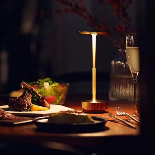 Orbit cordless lamp glowing on a dinner table