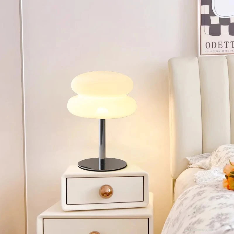 The Cloud Lamp on a bedside table